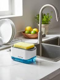 Modern kitchen sink with sponge holder, stainless steel faucet, and fruit bowl on countertop