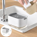 White kitchen sink soap dish with drainage holes, holding sponge, next to faucet on countertop